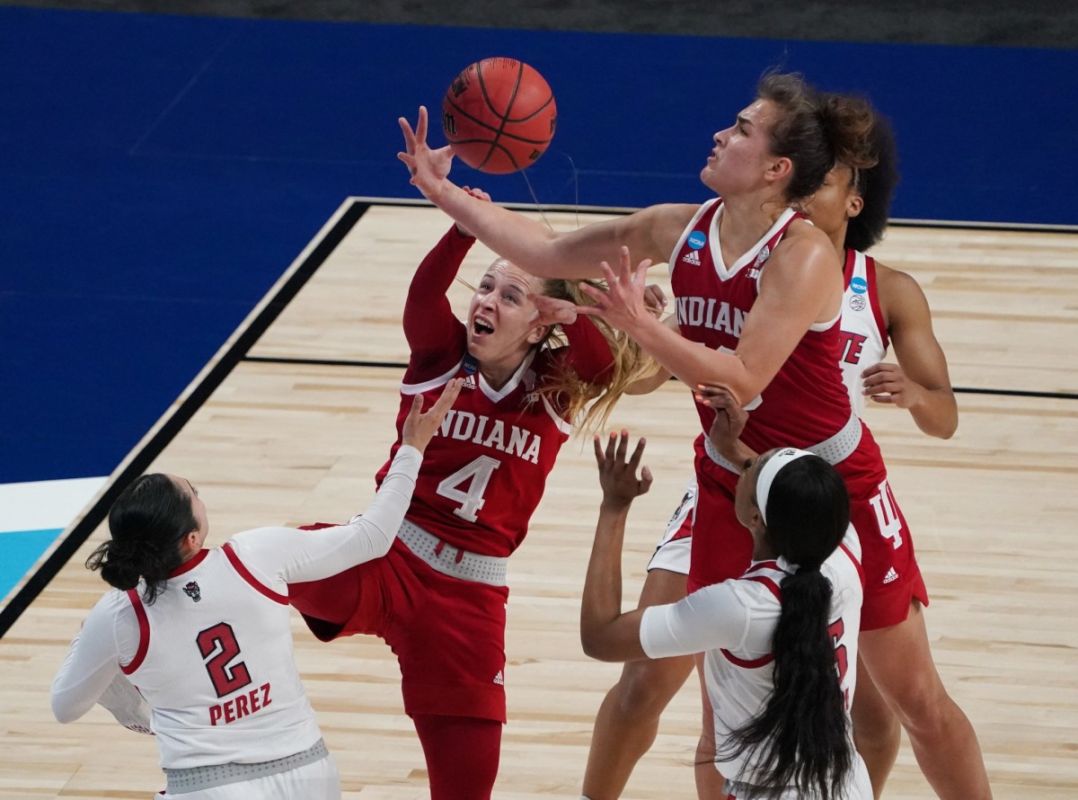 Mar 27, 2021; San Antonio, Texas, USA; Indiana Hoosiers guard Nicole Cardano-Hillary (4) and forward Aleksa Gulbe (10) battle for the ball against NC State Wolfpack guard Raina Perez (2) in the Sweet Sixteen of the 2021 Women's NCAA Tournament at Alamodome.
